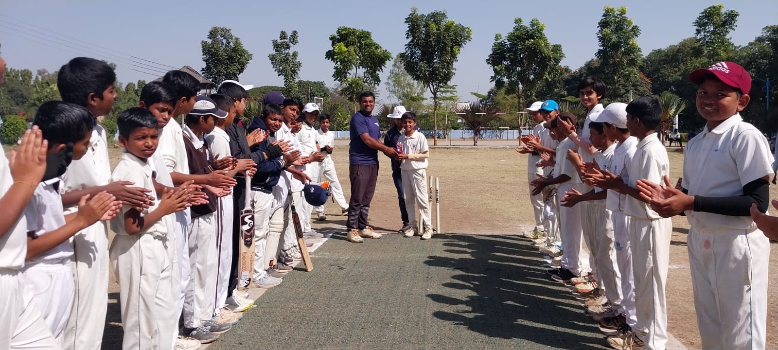 Players forming a guard of honour at an inter academy championship match